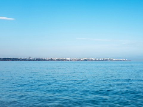 a body of water with a city in the distance