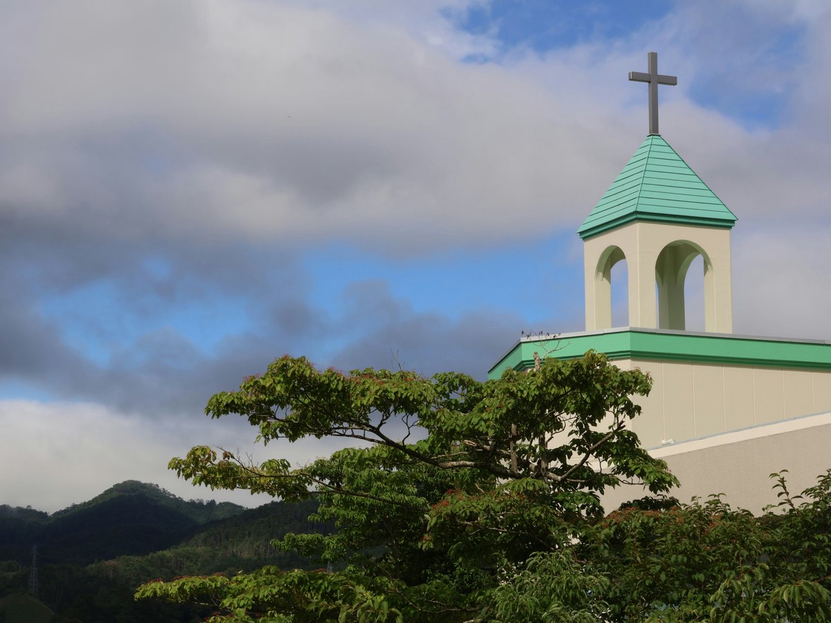 A church steeple with a cross on top of it