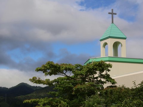 A church steeple with a cross on top of it