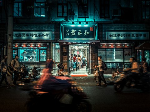 motorcycles and people passing by at night time