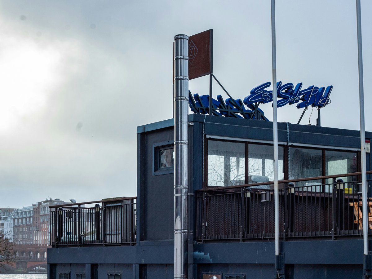 a blue building with a sign on top of it