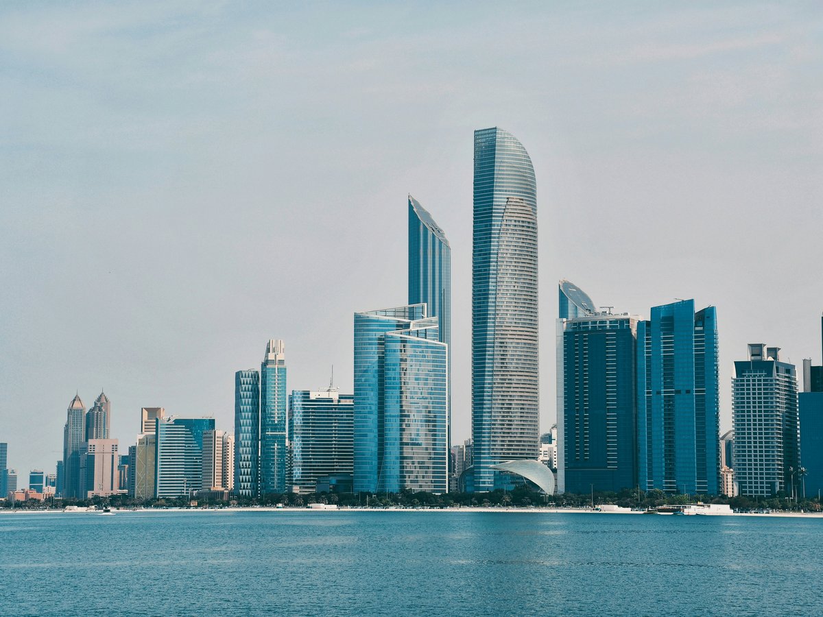 a city skyline with a body of water in the foreground