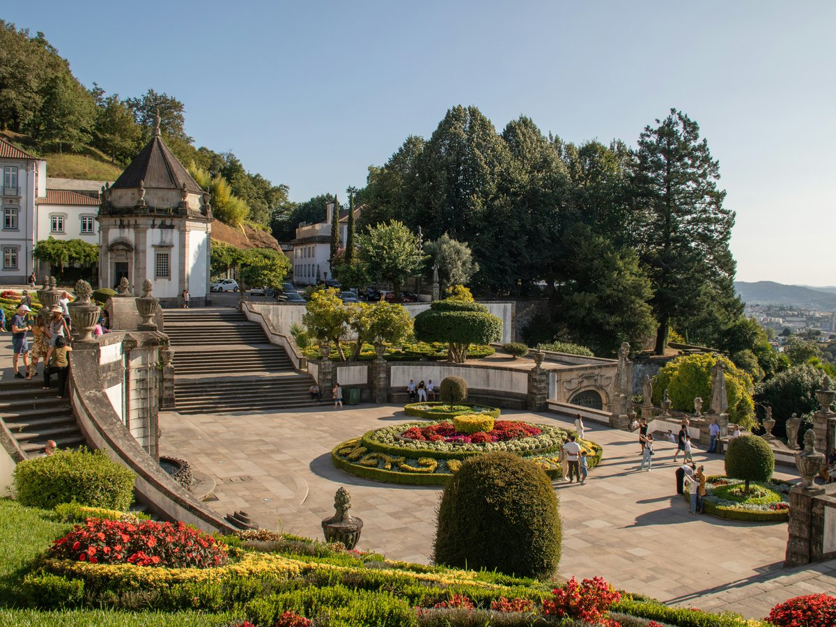 A scenic view of a park with a lot of flowers