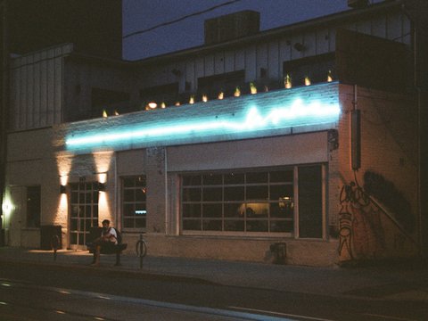 people walking on sidewalk near building during night time