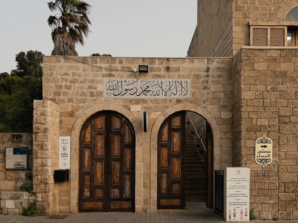 a building with two doors and a sign on it