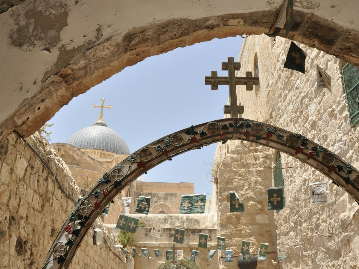 a church with a cross hanging from it's side