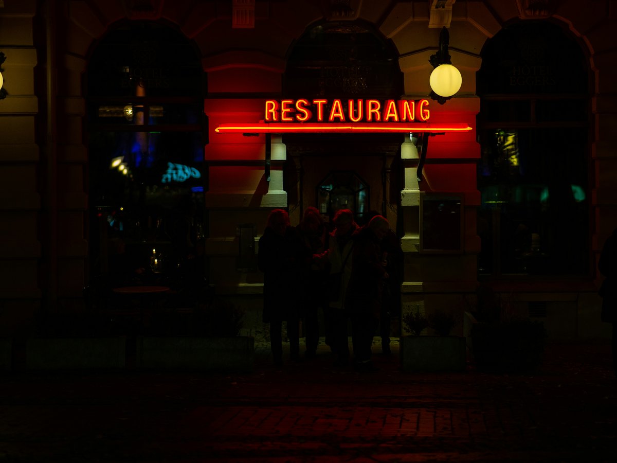 A restaurant sign lit up in the dark