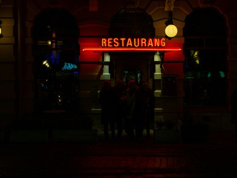 A restaurant sign lit up in the dark