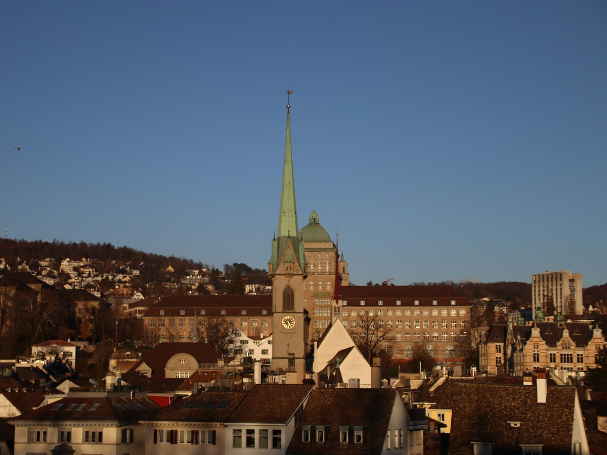 a view of a city with a steeple in the background