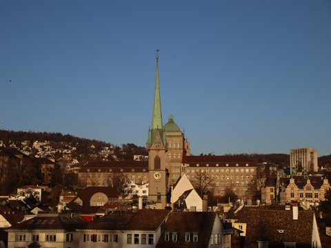 a view of a city with a steeple in the background