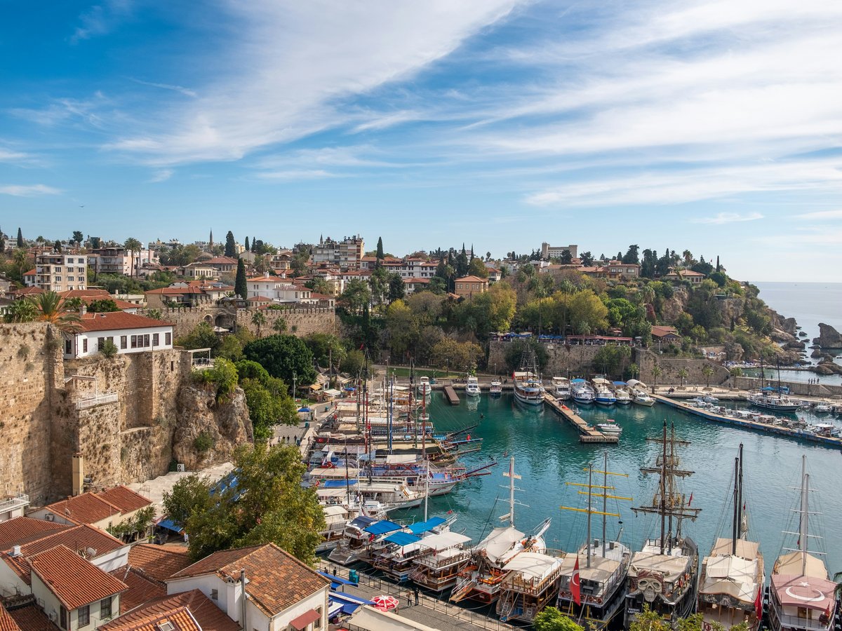 a harbor filled with lots of boats next to a city