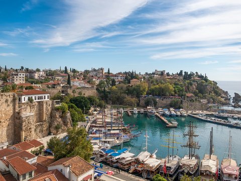 a harbor filled with lots of boats next to a city
