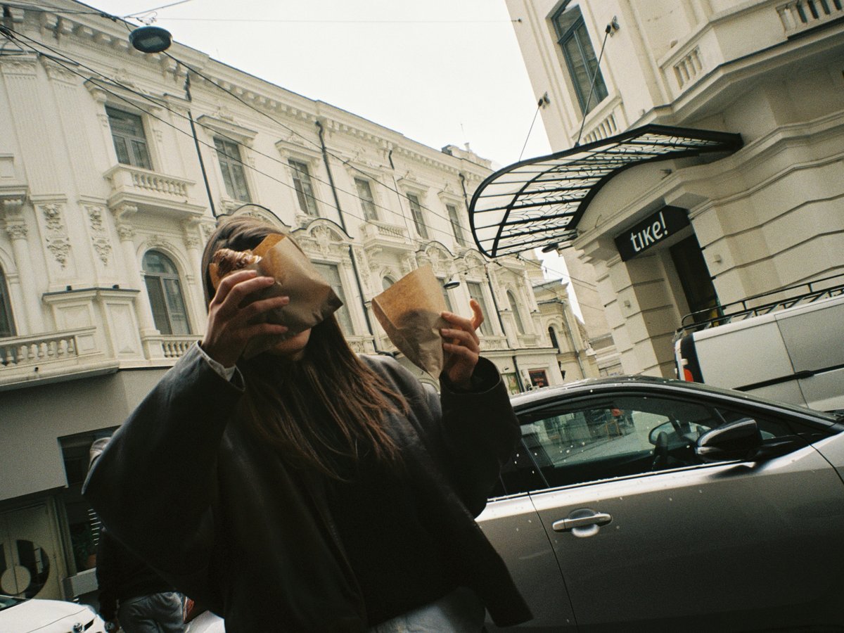 a woman holding a cup of coffee in front of her face