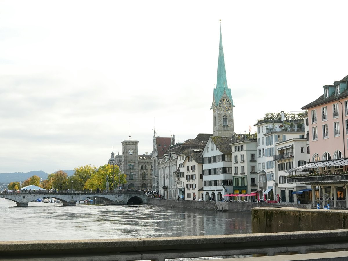 a river running through a city next to tall buildings