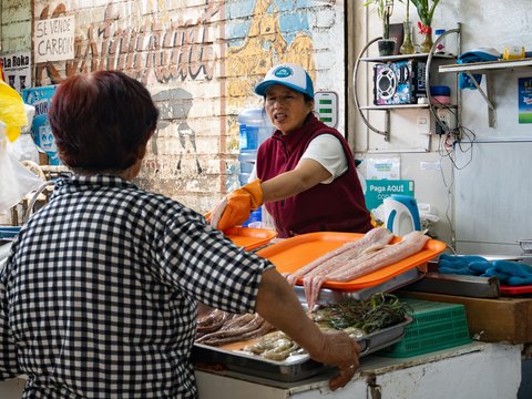A man and a woman standing at a counter