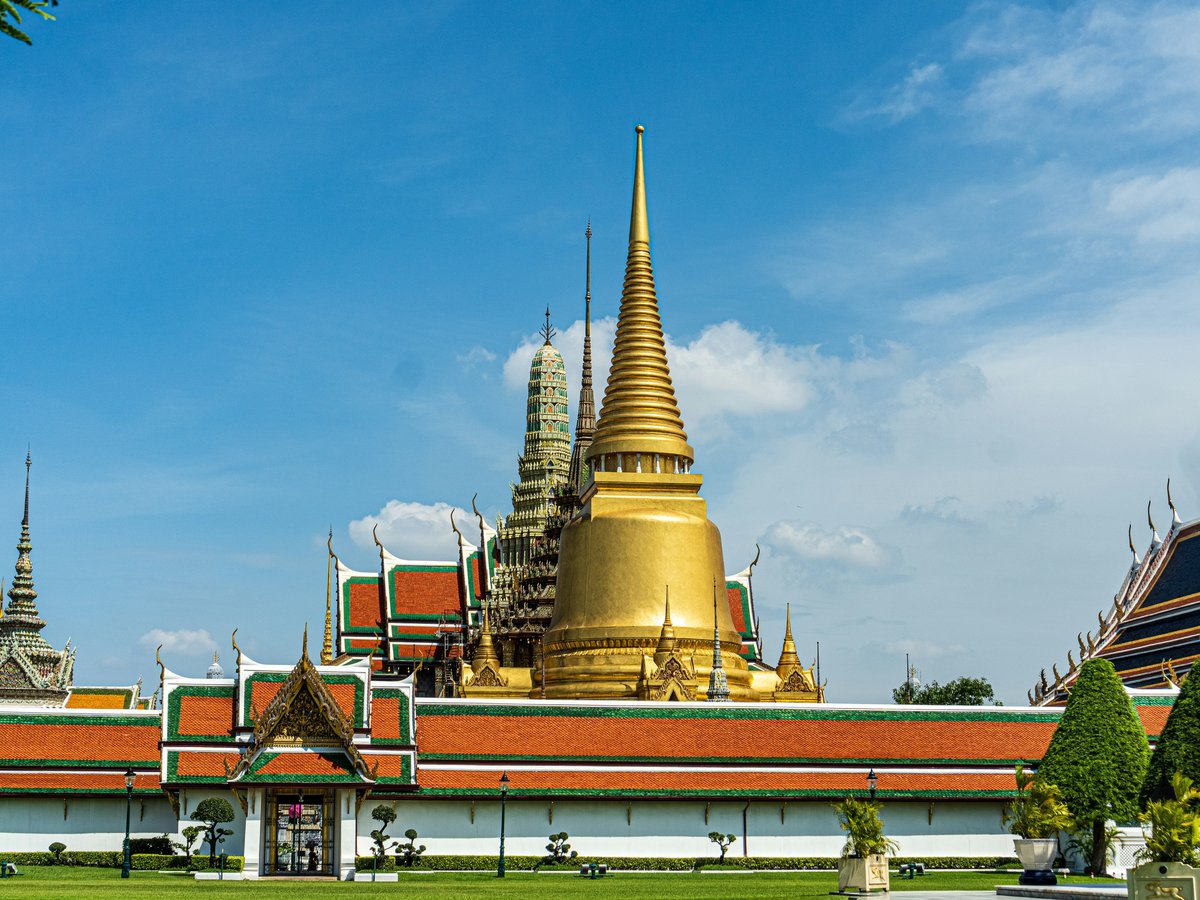 gold and red temple under blue sky