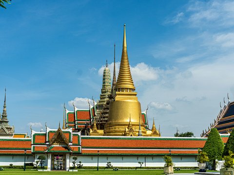 gold and red temple under blue sky