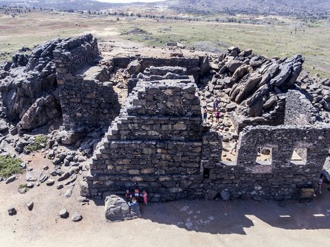 a stone building on a rocky hill