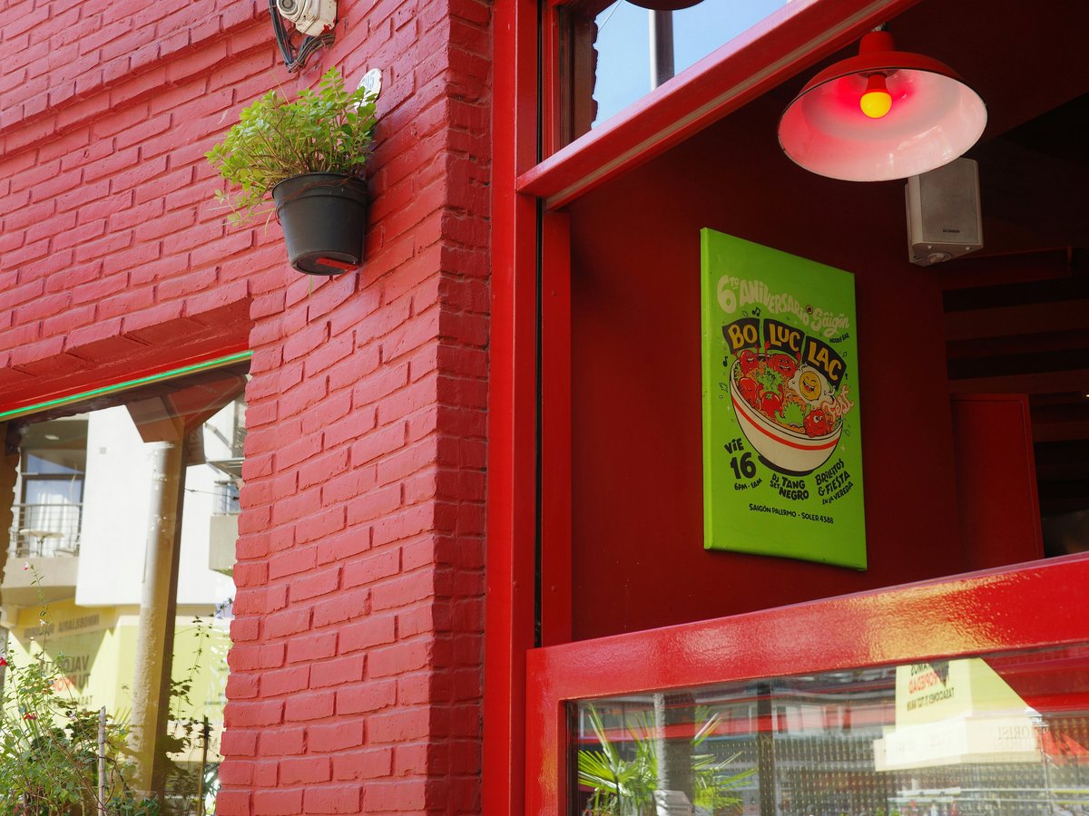 Red brick building with a green sign
