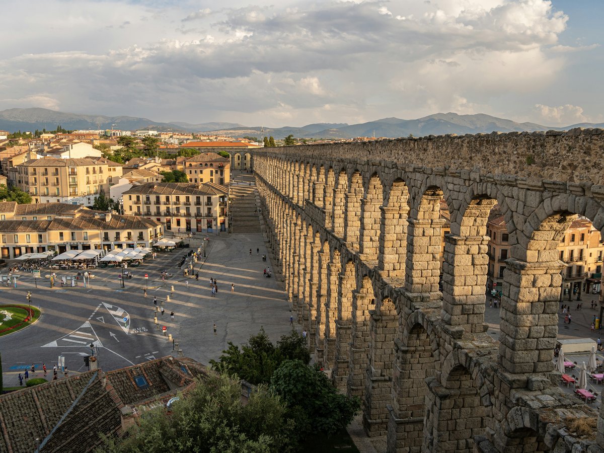 a large stone bridge over a parking lot
