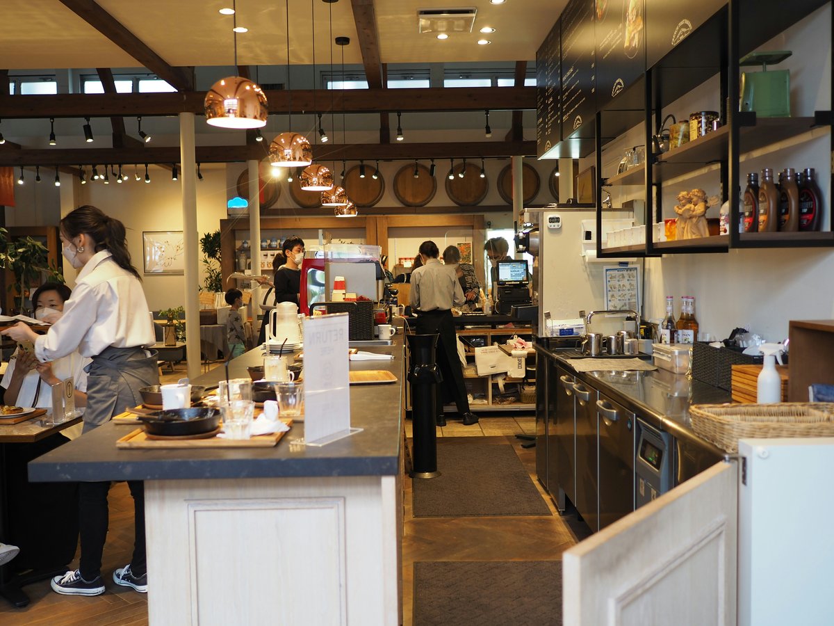 a group of people stand in a kitchen
