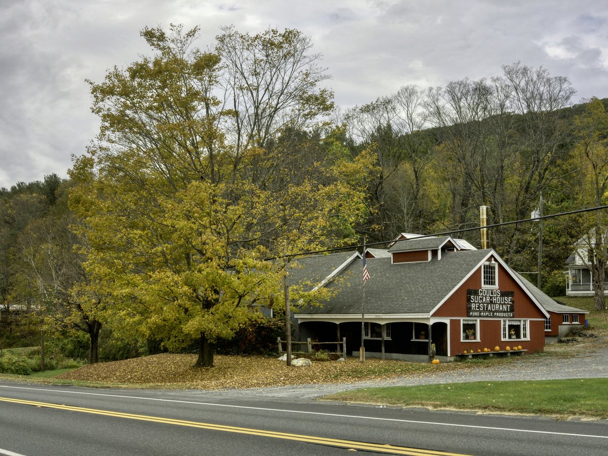 a red building sitting on the side of a road