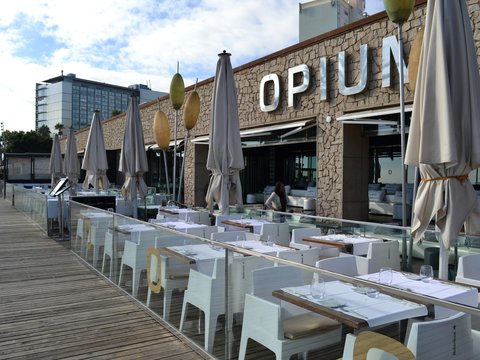 a row of tables with umbrellas outside of a restaurant