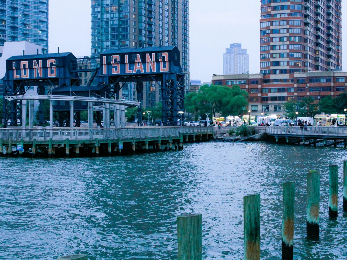 a body of water next to a city with tall buildings