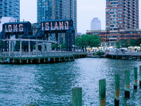 a body of water next to a city with tall buildings