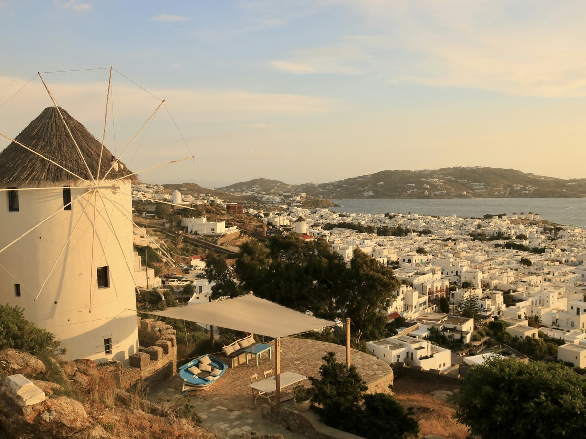 a windmill on a hill overlooking a city