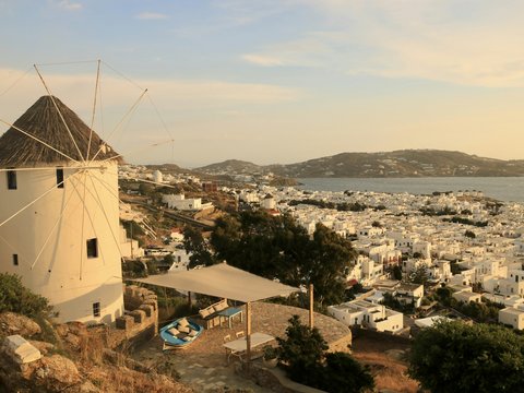 a windmill on a hill overlooking a city