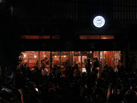 A group of motorcycles parked in front of a building