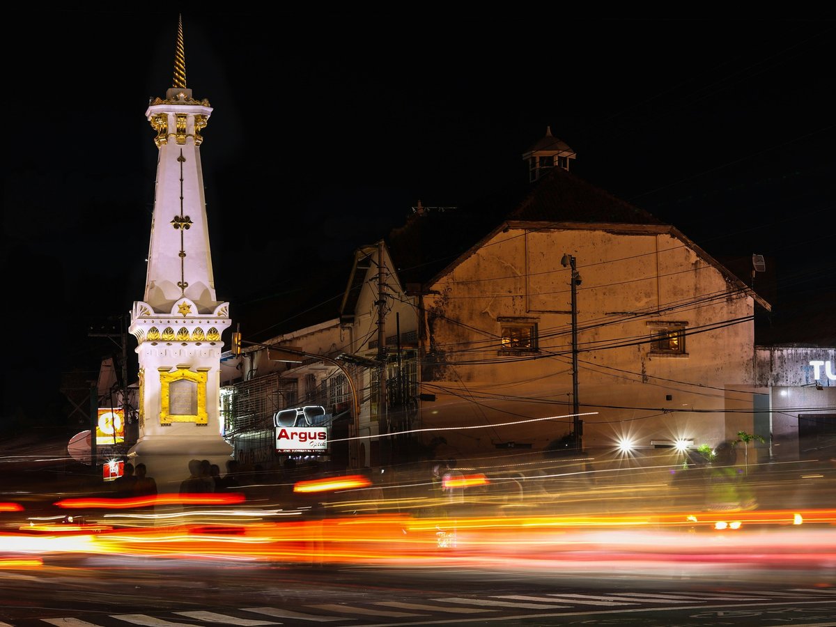 a very tall clock tower towering over a city at night