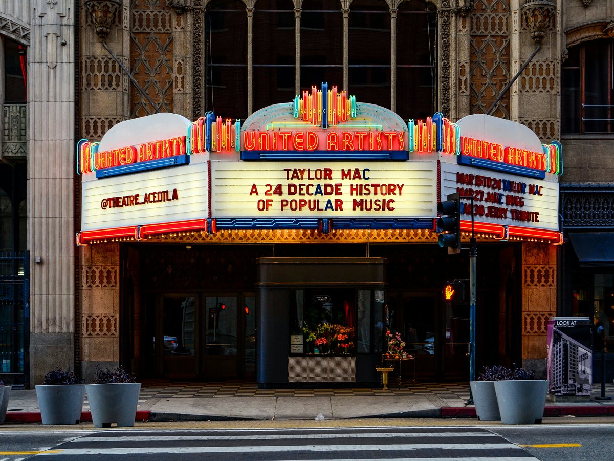 a theater marquee with a crosswalk in front of it