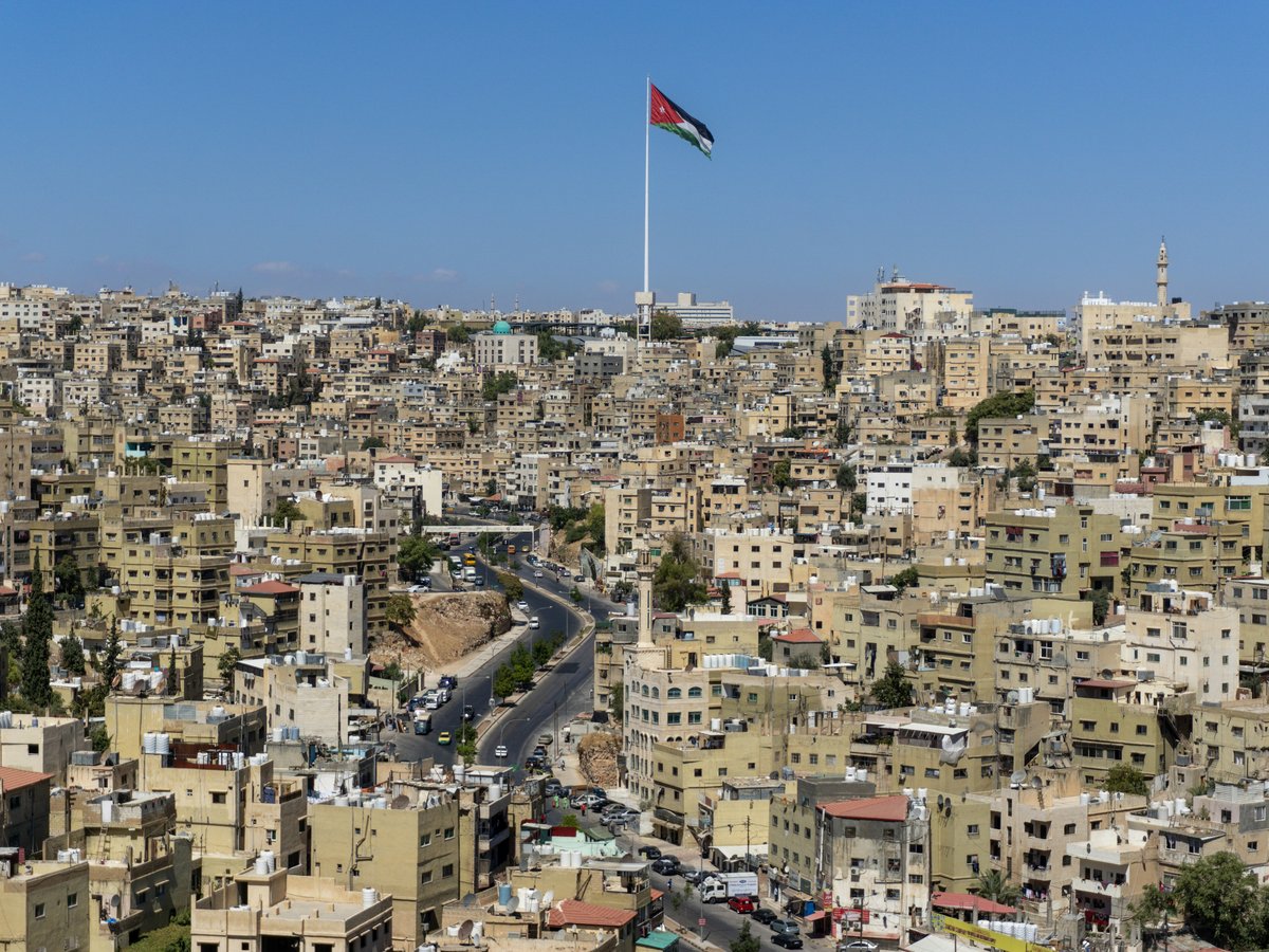 A view of a city with a flag on top of it