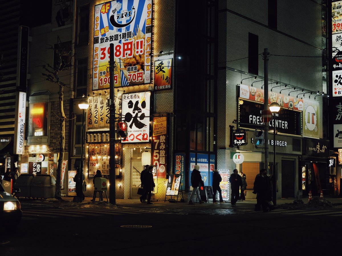 City street at night with bright neon signs.