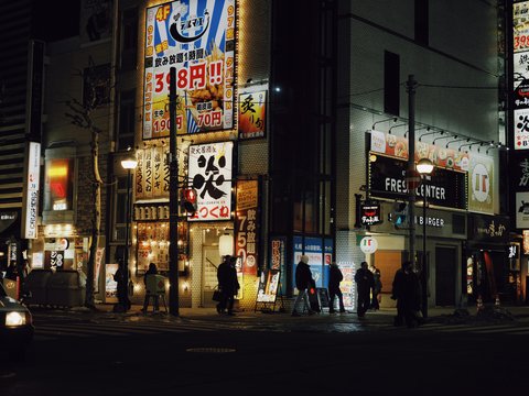 City street at night with bright neon signs.