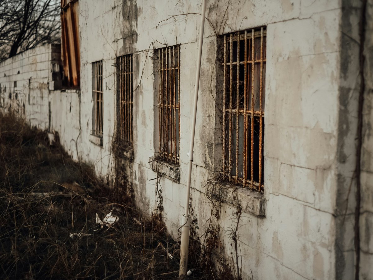 white concrete building with brown wooden window