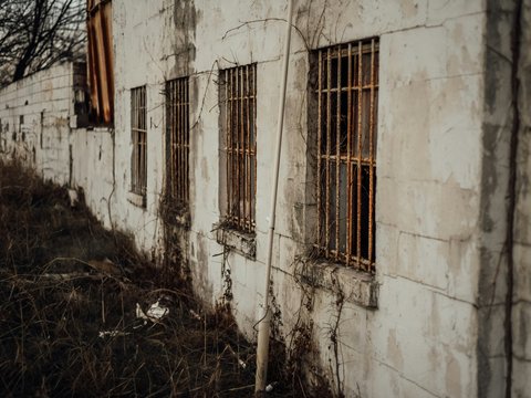 white concrete building with brown wooden window
