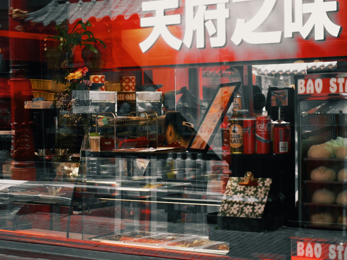 a store front with a glass display case in front of it