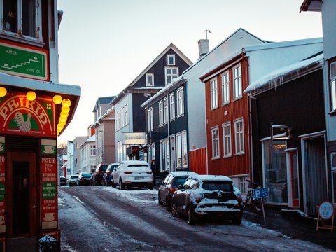 cars parked in front of brown building during daytime