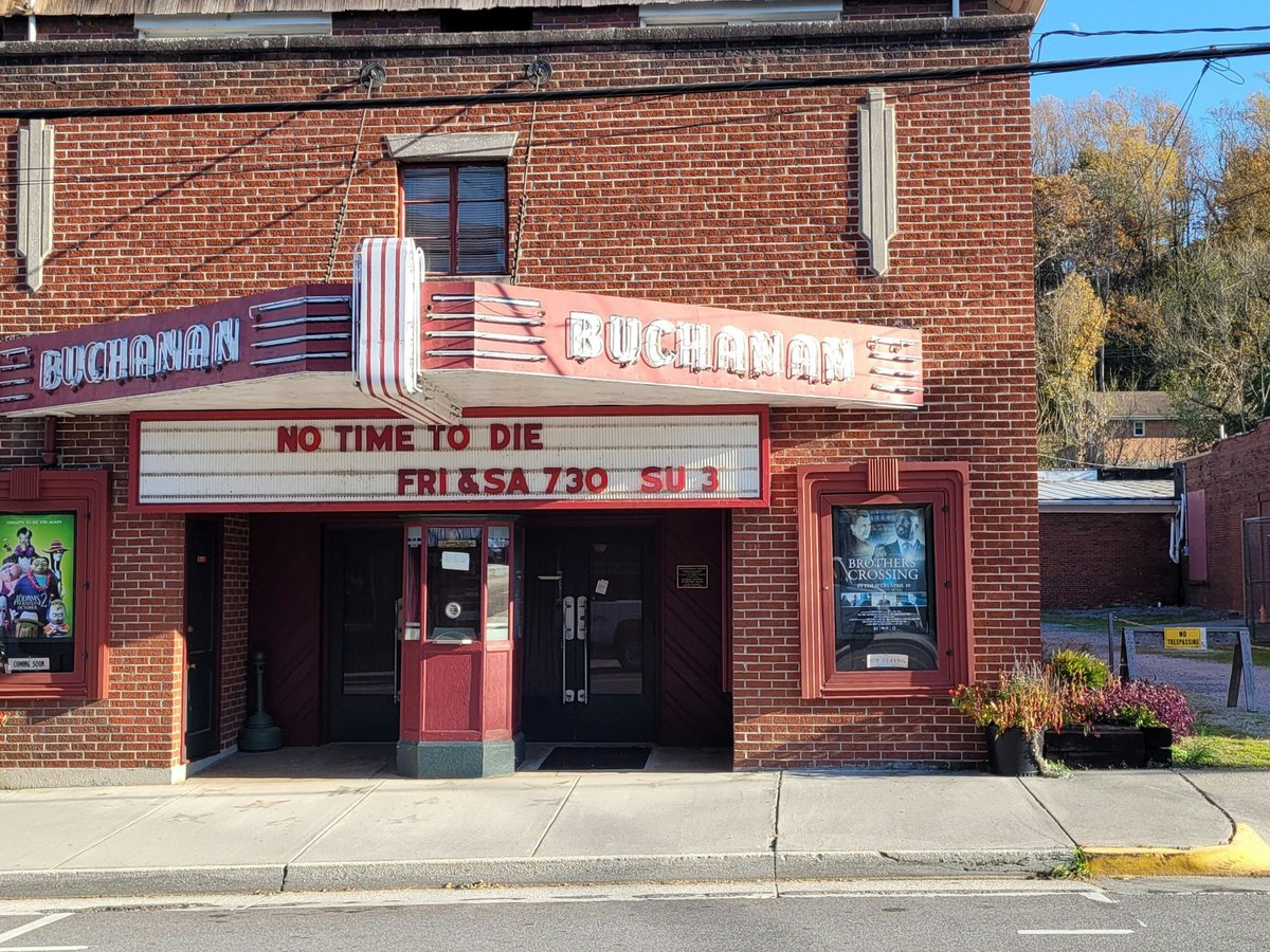 a brick building with a theater sign on the front of it