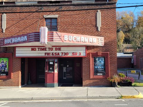 a brick building with a theater sign on the front of it