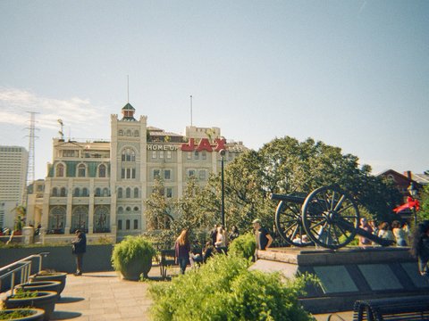 Cannon sits in front of a large building
