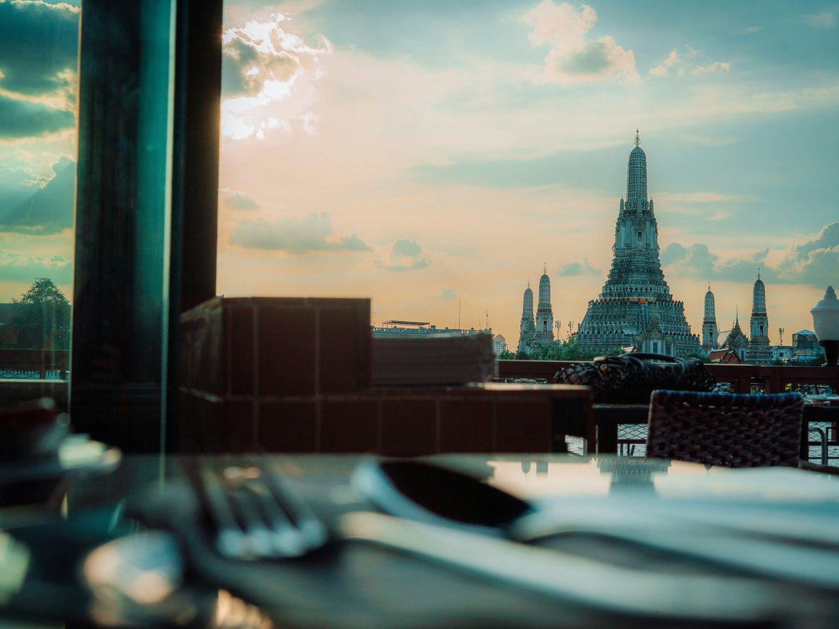 Temple spire against a cloudy sunset sky.