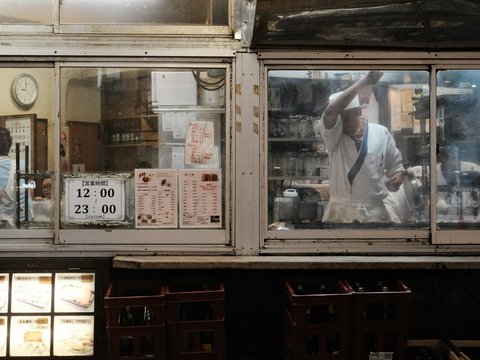 A man standing in front of a store window