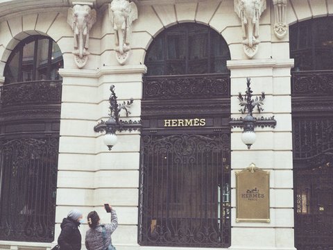A couple of people that are standing in front of a building