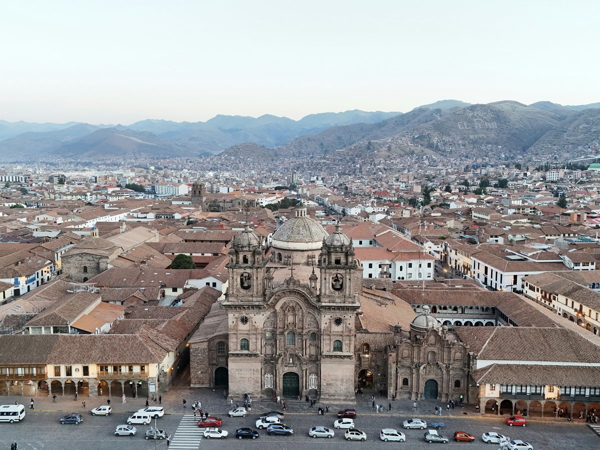 An aerial view of a city with a large cathedral