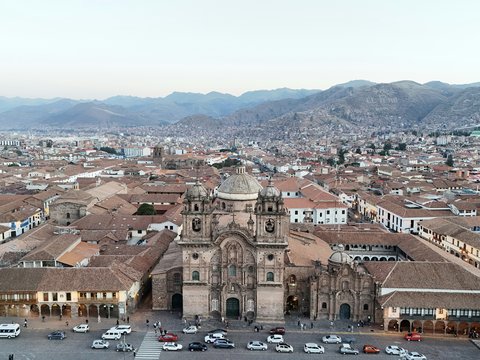 An aerial view of a city with a large cathedral