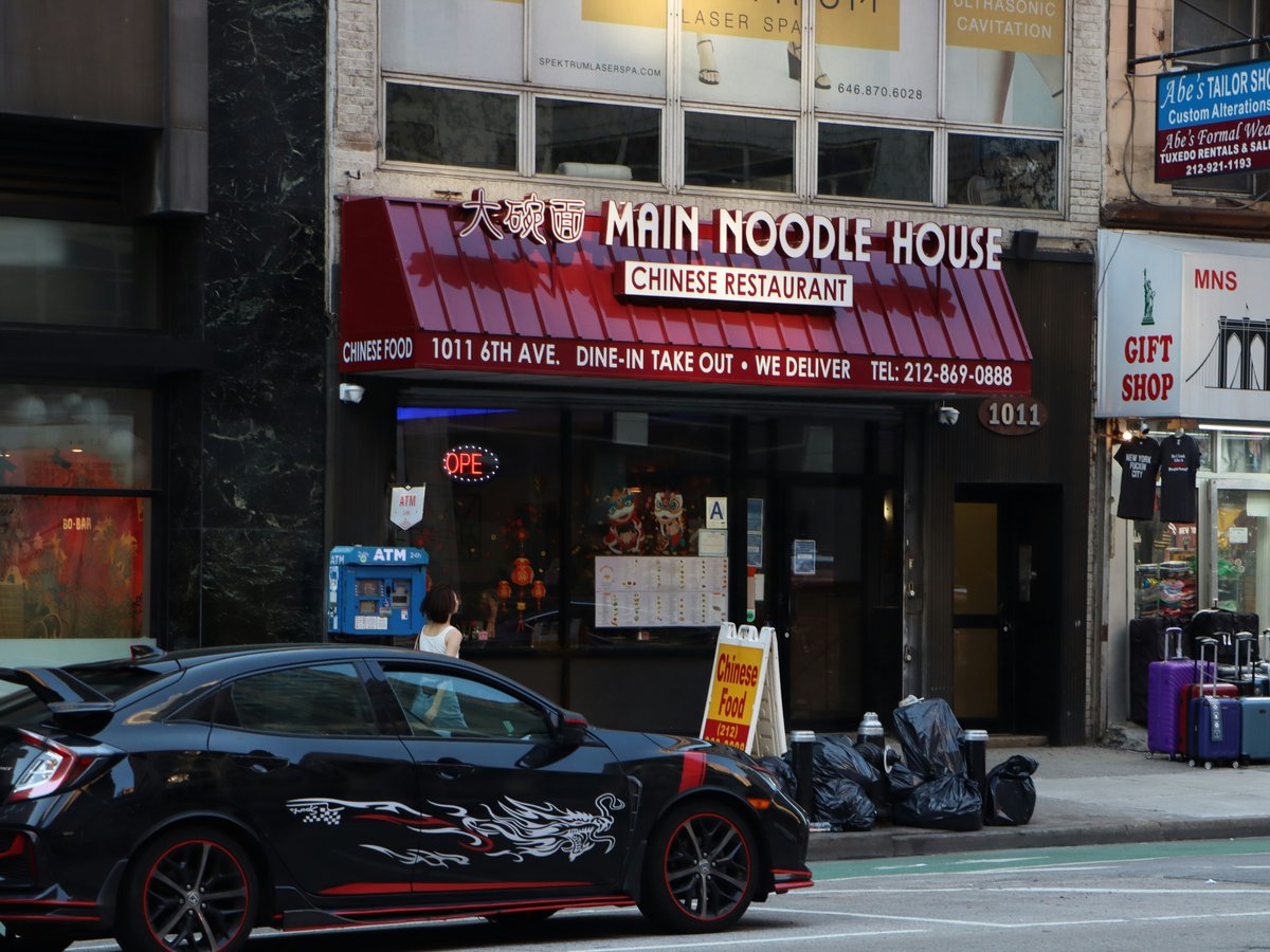 a car parked on the side of the road in front of a building
